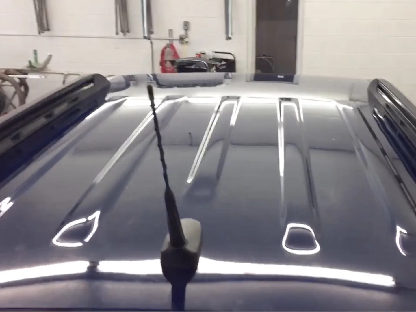 Hail-dented car panel restored with paintless dent repair — after