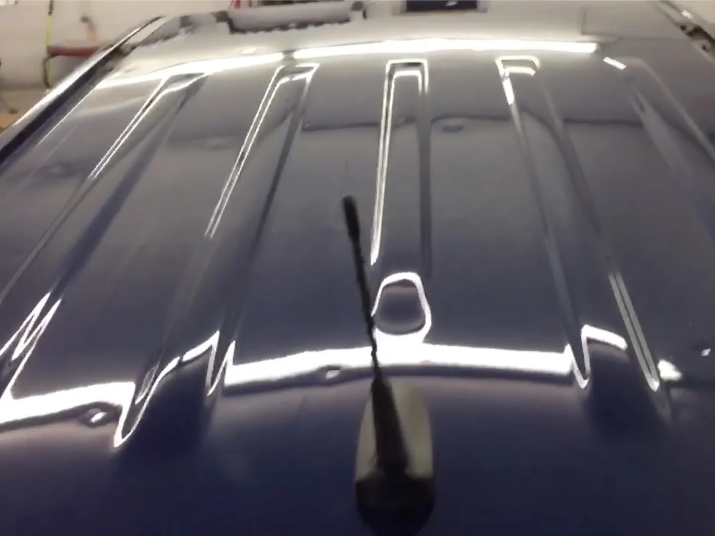 Hail-dented car panel restored with paintless dent repair — before
