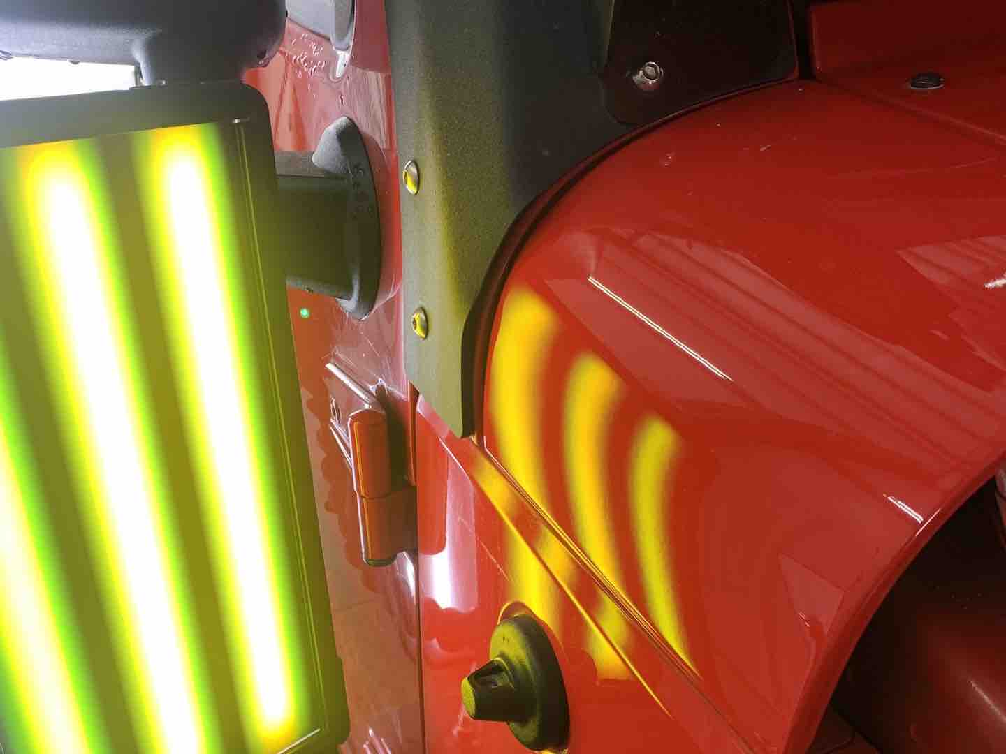 Paintless dent repair of a dent on a Jeep body panel — after