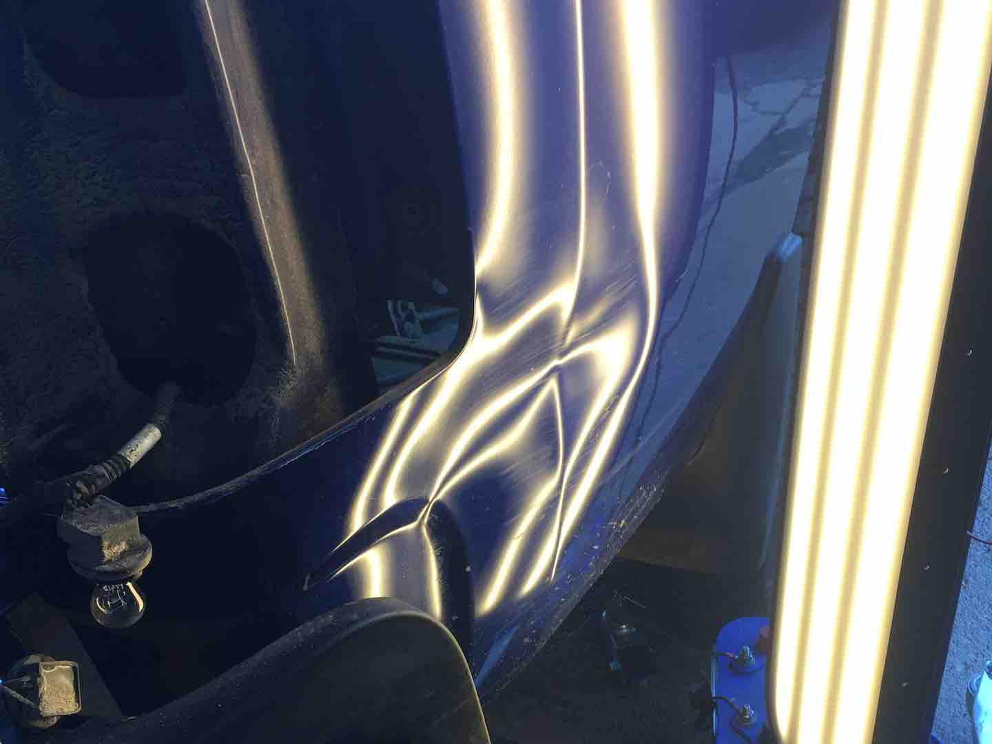 Paintless dent repair of a dent on a truck panel — before